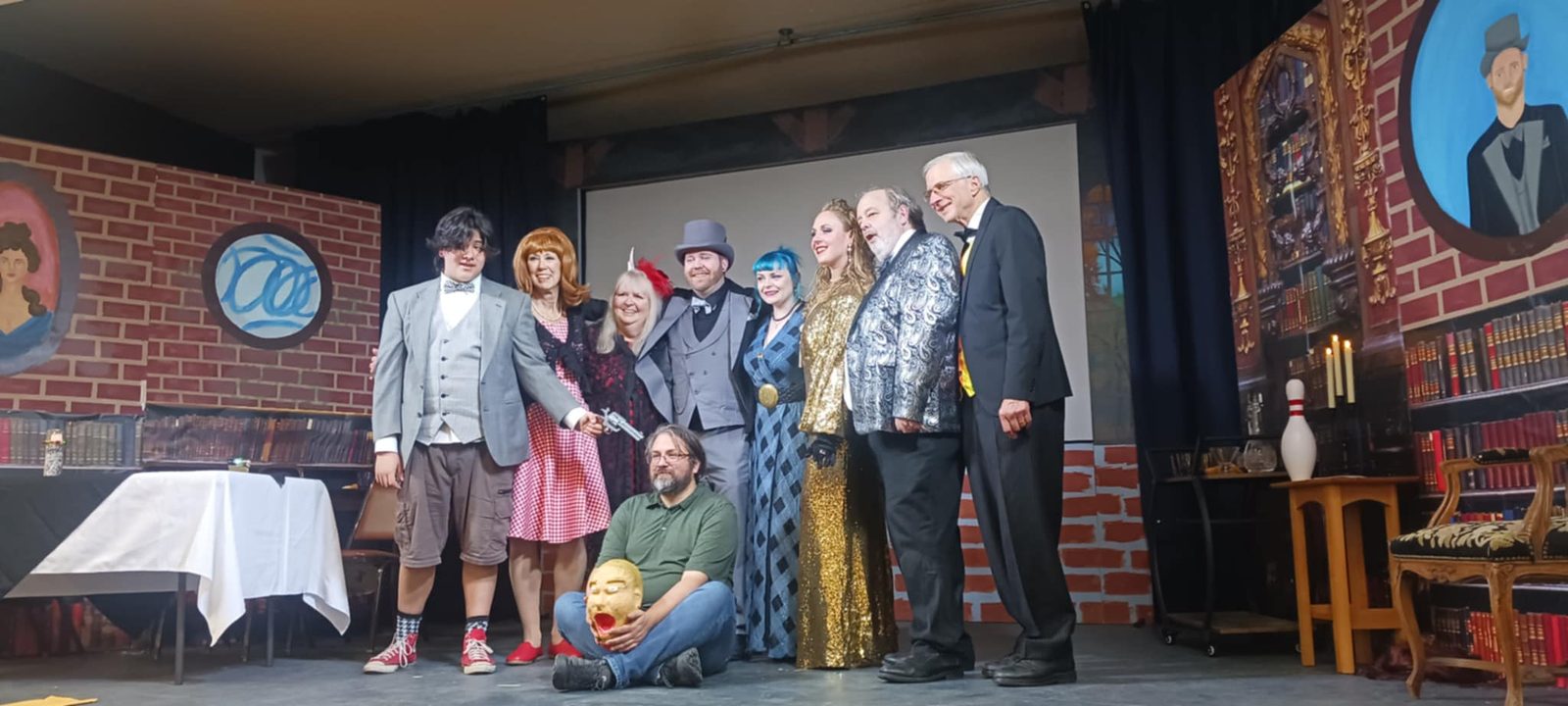 The cast on stage in costume at the end of a recent show